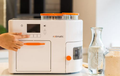 A person is pressing button of Rotimatic machine